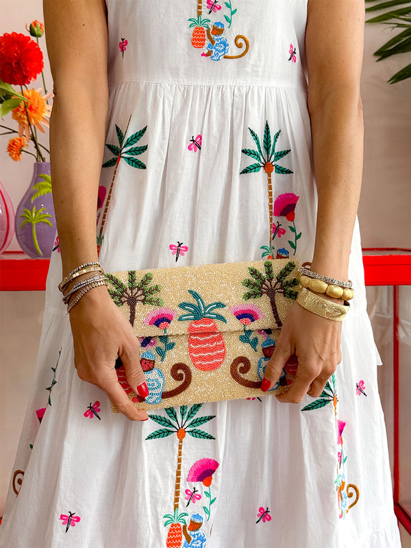 Artisan beaded envelope bag with detachable gold chain and tropical scene in coral, green and blue