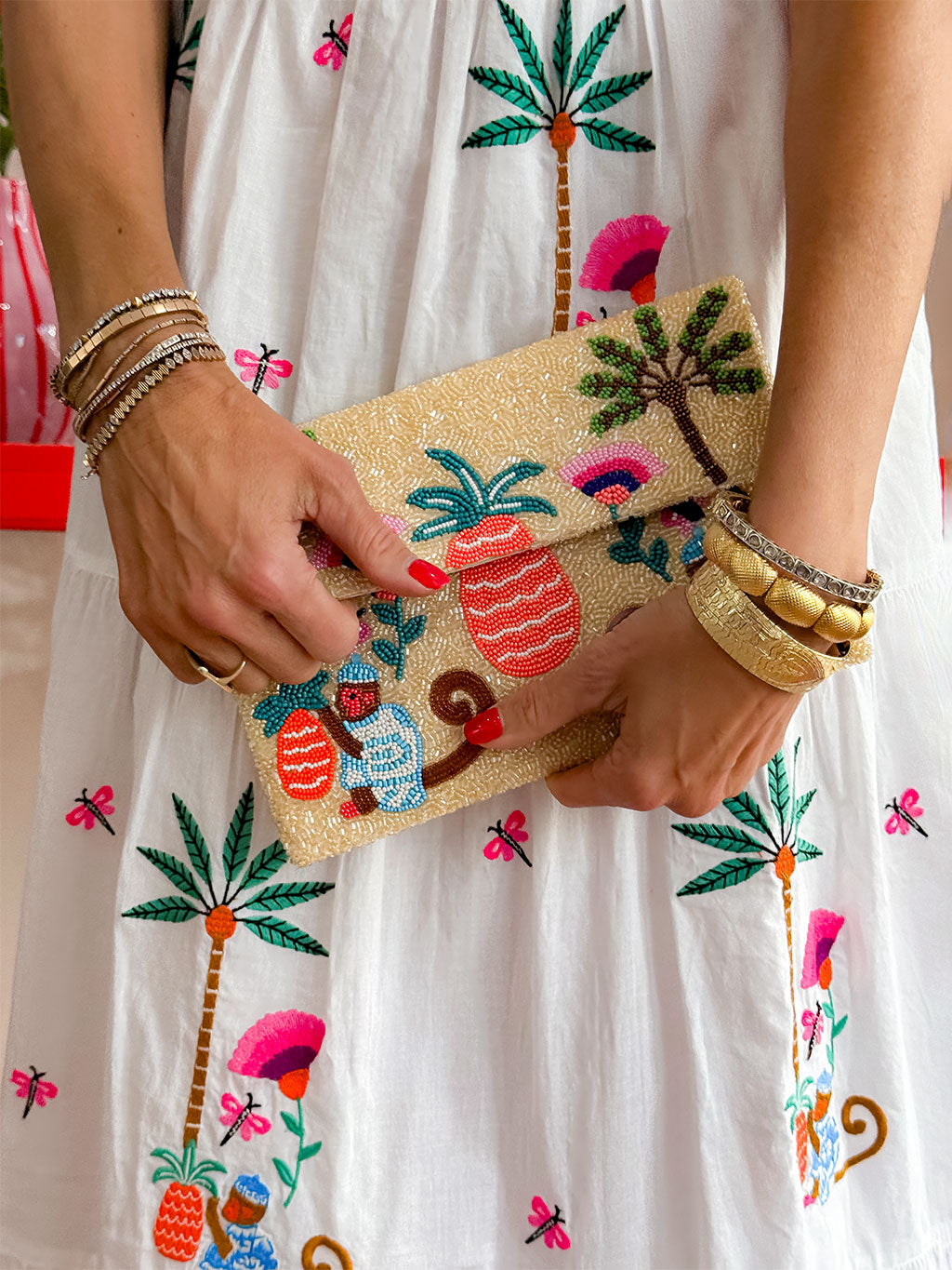 Artisan beaded envelope bag with detachable gold chain and tropical scene in coral, green and blue