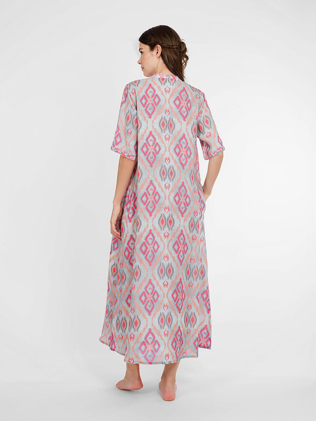 Rear view of the Cassia linen dress showcasing the straight, effortless drape and the rhythmic ikat pattern.