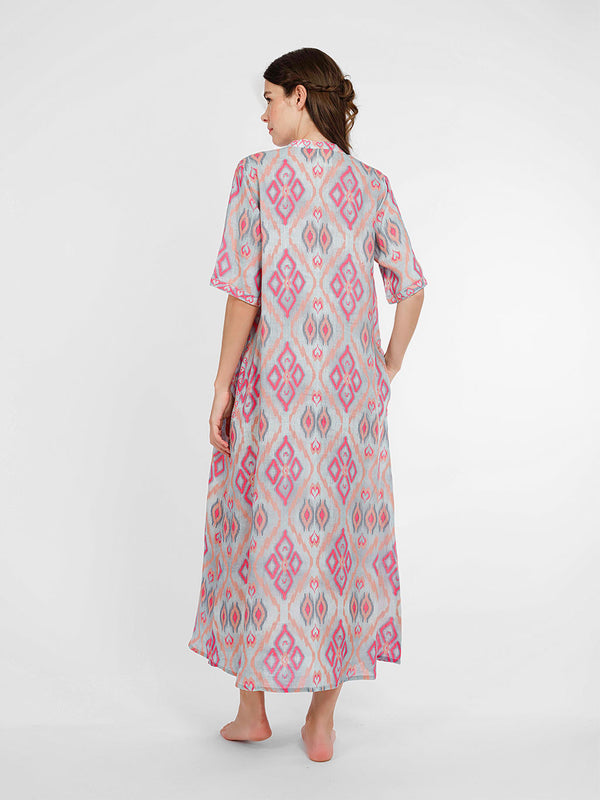 Rear view of the Cassia linen dress showcasing the straight, effortless drape and the rhythmic ikat pattern.