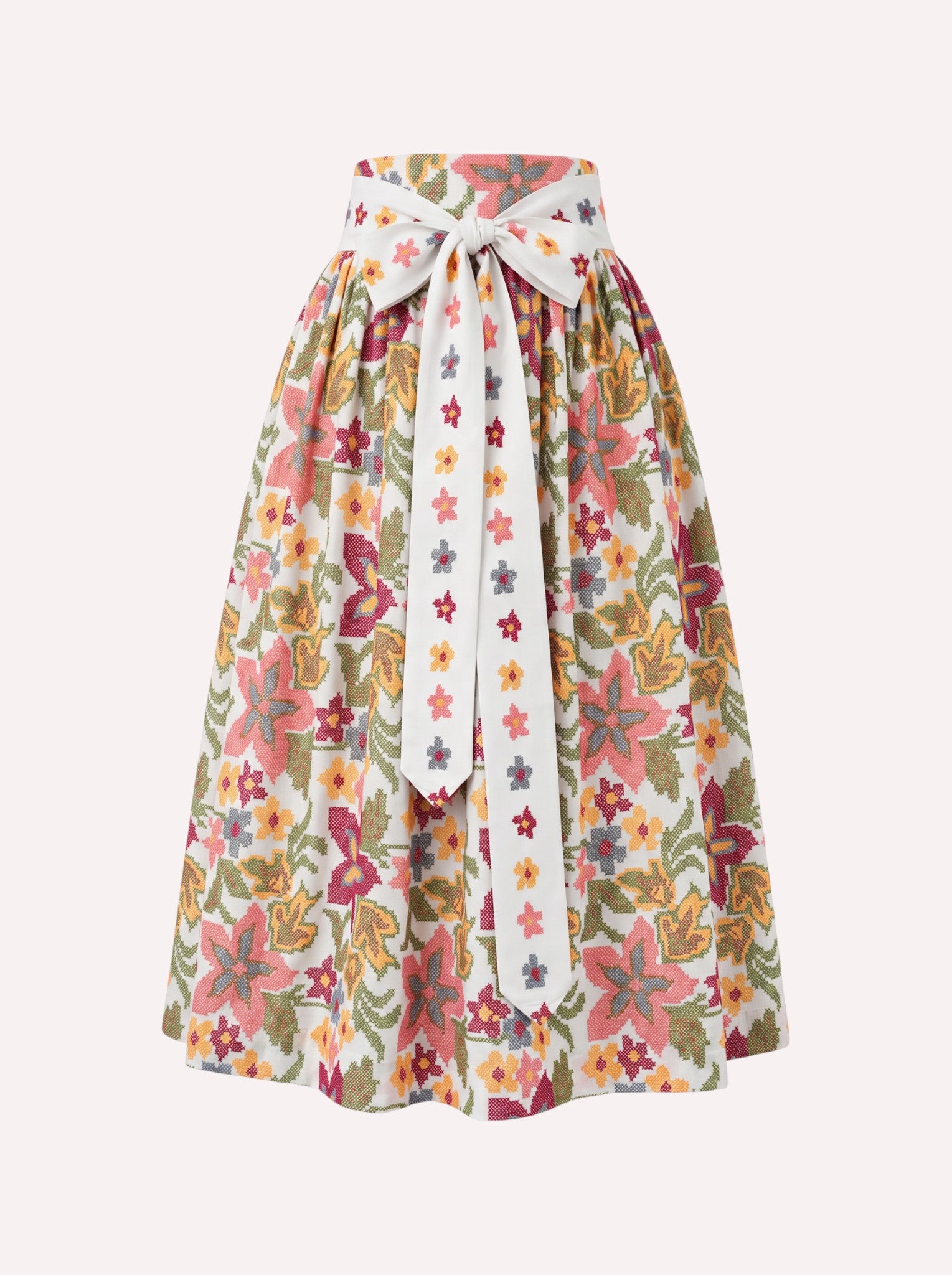 Nimo x Münchner Manufaktur cotton dirndl apron featuring an all-over vibrant green and red floral cross-stitch pattern.