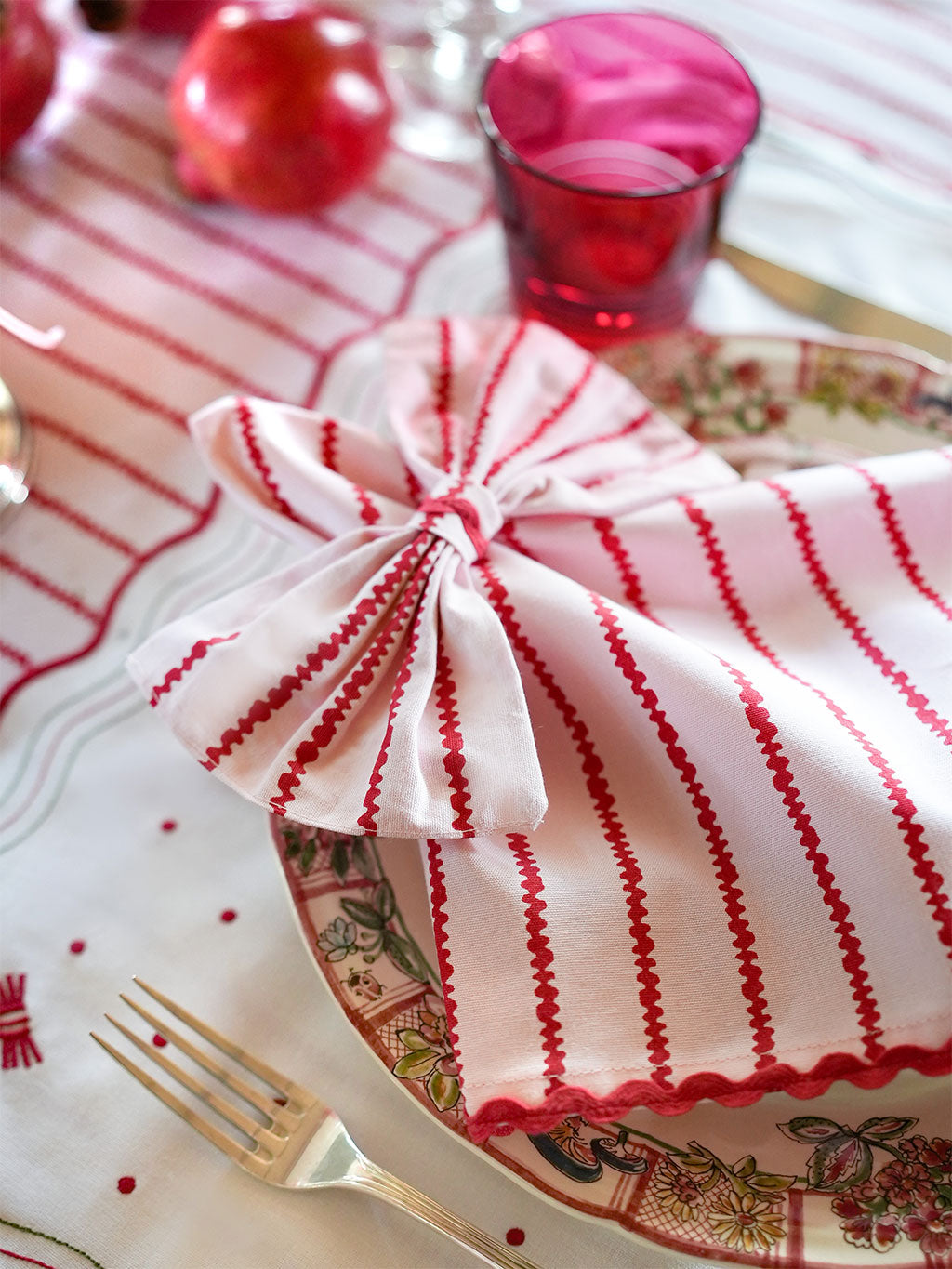 Red and white striped napkin with a bow napkin ring made from striped cotton
