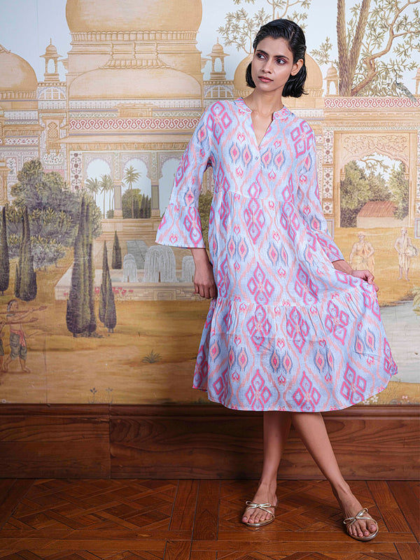 Close-up of the tiered skirt and the vibrant diamond ikat pattern on the breathable linen fabric.