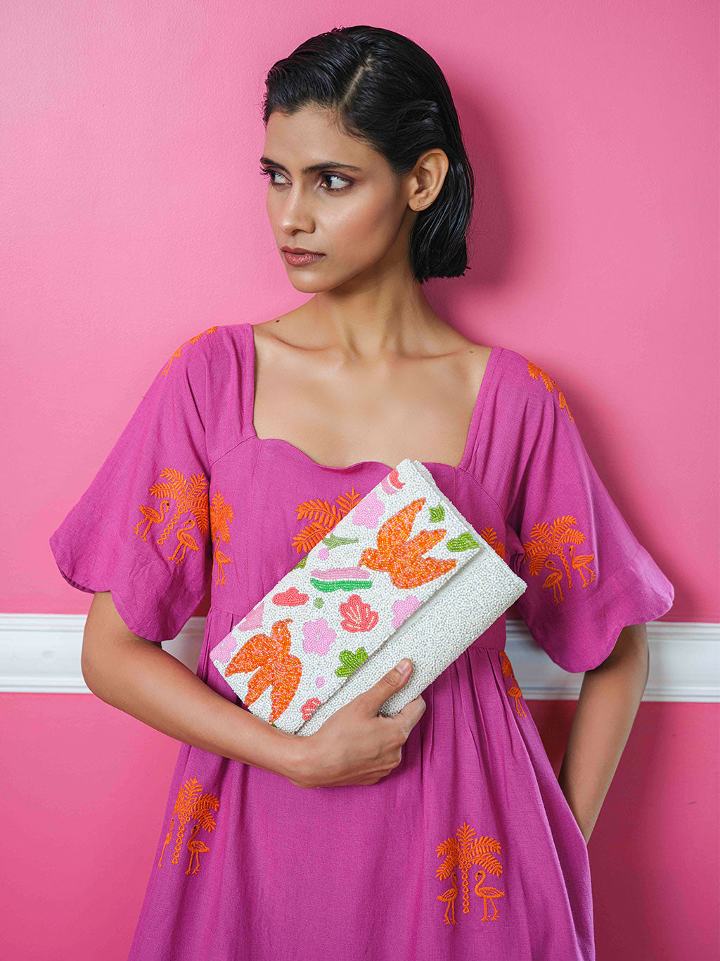 High-vibing hand-beaded envelope clutch with luxury bohemian bird motifs. Ready to style any summer and resort look for luxury vacations