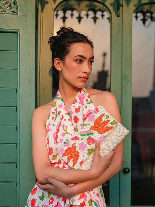 Hand-beaded luxury resort clutch with an envelope silhouette. Style any summer outfit with this high-society-ready bag, suitable for any resort look from Saint Tropez to the Caribbean.