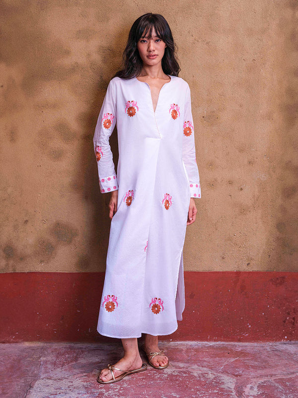 White organic cotton Amethyst Kaftan dress by Nimo With Love with pink and orange bird embroidery and a wrap-effect neckline.