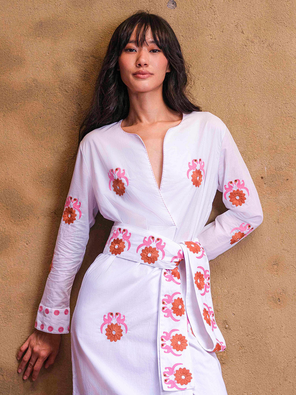 Model wearing the ultra-long Gujarat Birds belt wrapped around a white embroidered kaftan to define the silhouette