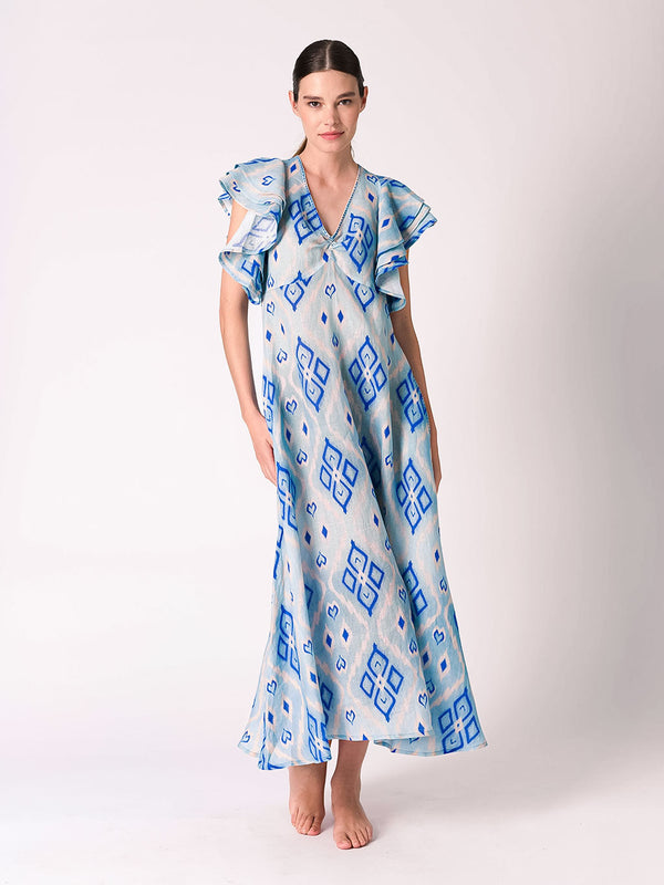 Woman wearing a blue and white patterned designer maxi summer dress witha relaxed yet refined fit