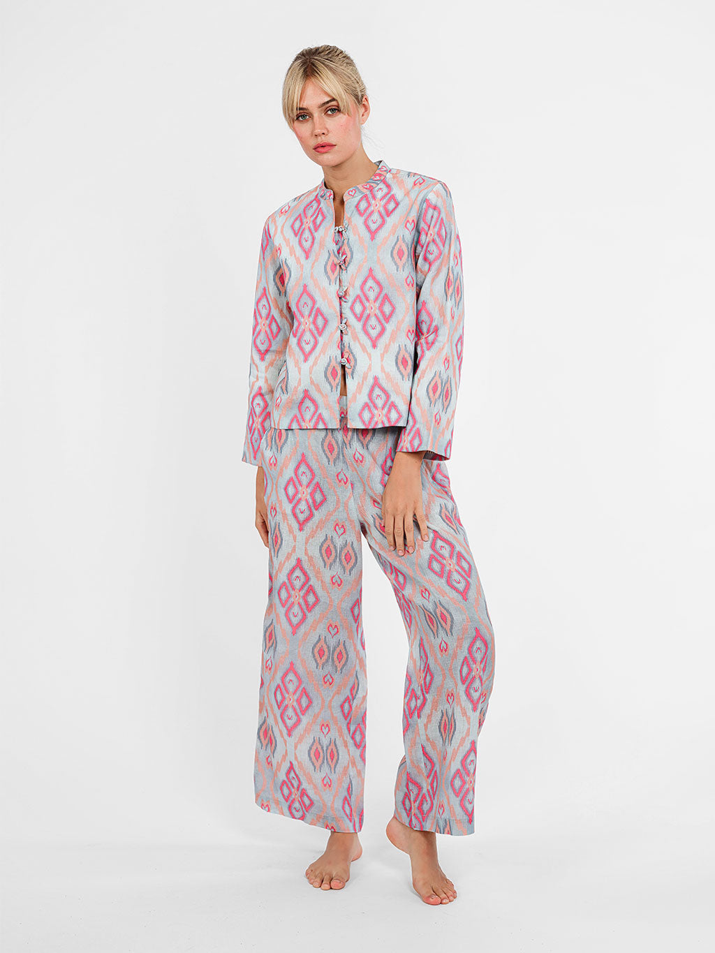 Model wearing the Fennel wide-leg linen pants in ikat pink sorbet, paired with the matching mandarin jacket.