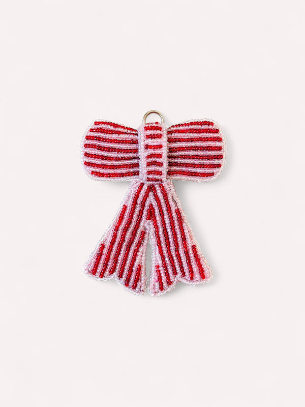 Decorative beaded bow Christmas ornament in red and pale pink stripes