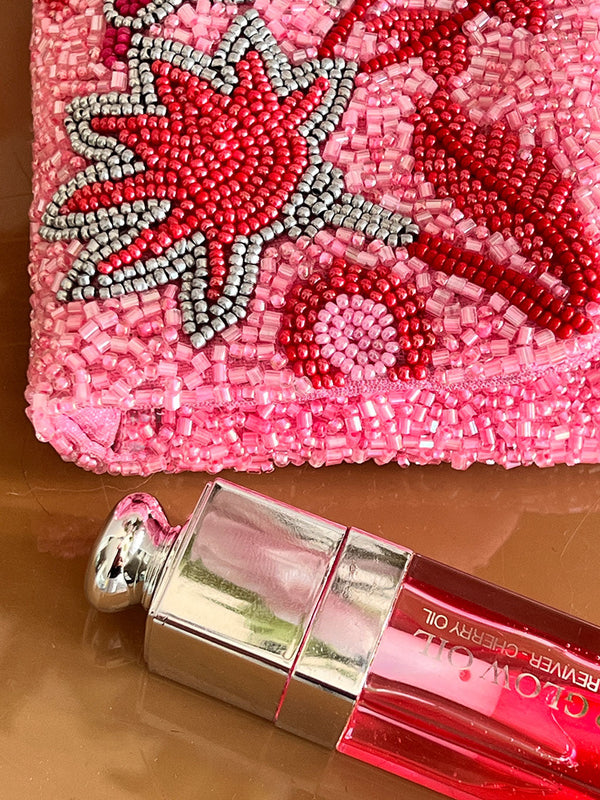 Nimo with Love pink beaded clutch with handcrafted floral and bird motif. Artisanal envelope bag featuring intricate bird and flower embroiderey