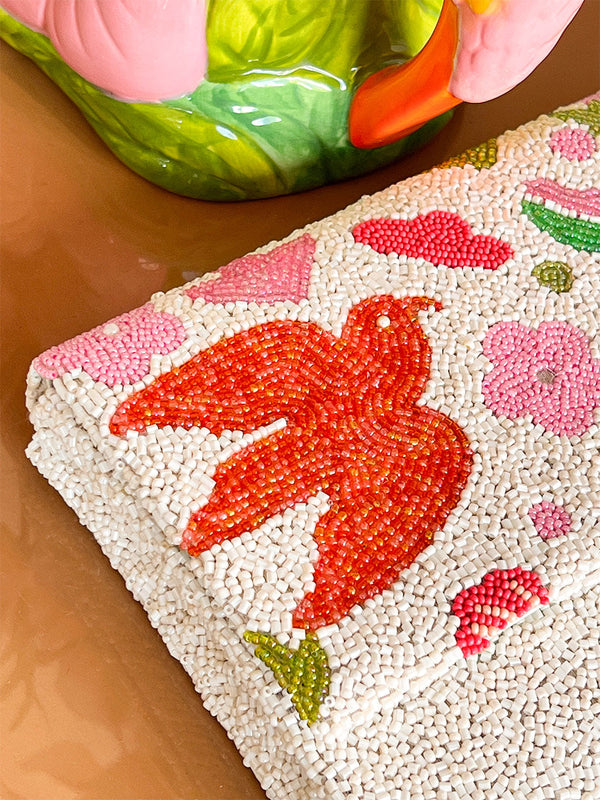 Close-up of a beaded purse with a red bird design