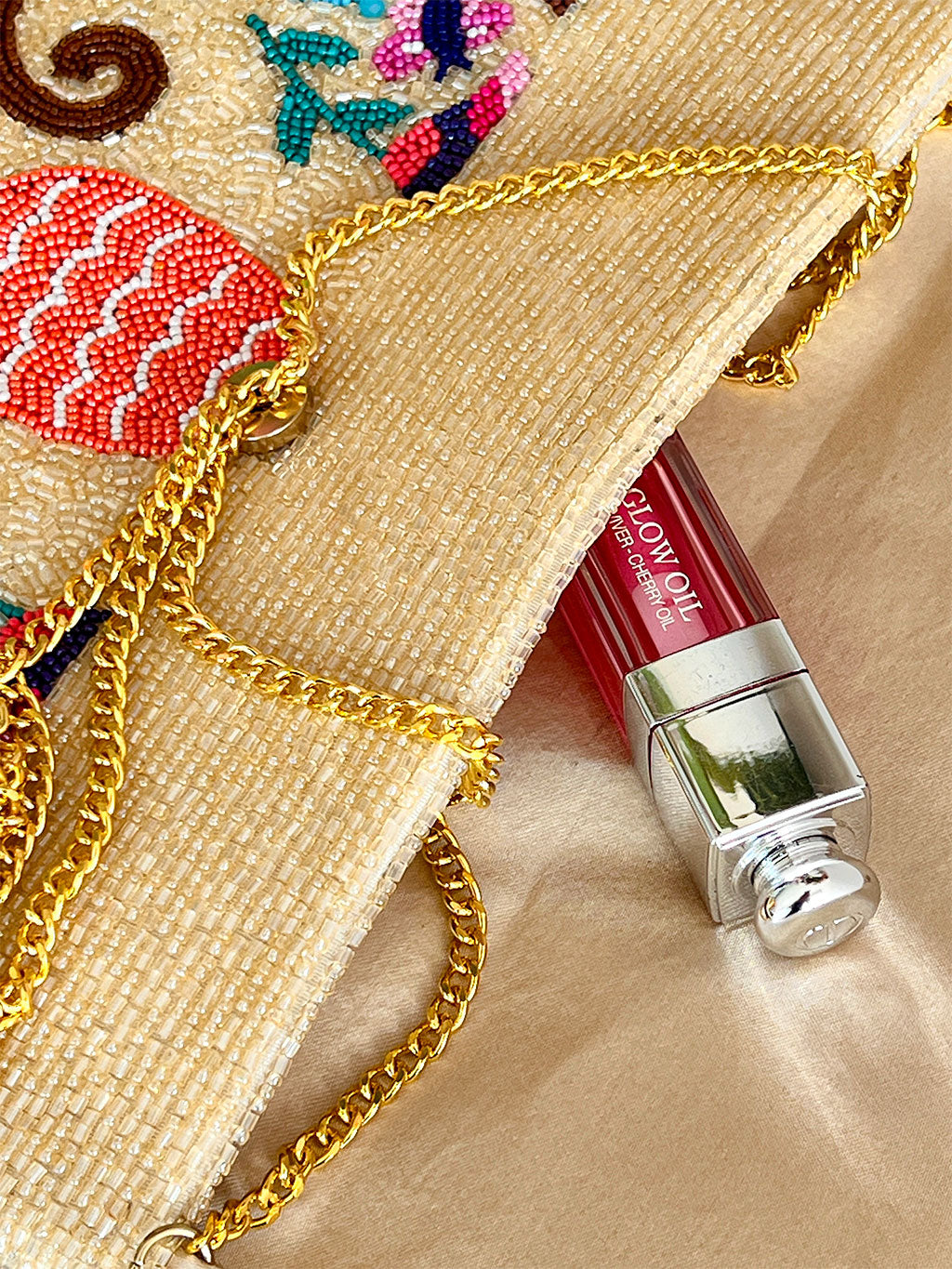 Sand beige handcrafted bead clutch with flap closure and removable gold chain by Nimo With Love