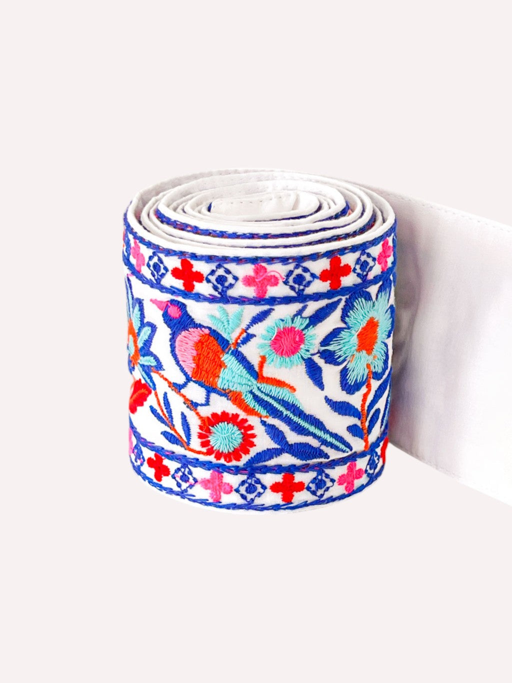 An embroidered, bohemian fabric belt for nyone seeking a versatile accessory to transition outfits from basic daywear to distinctive evening looks.