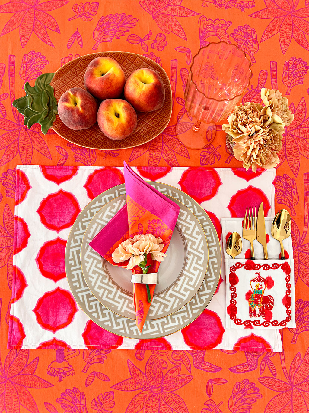 Sophisticated bohemian dining room decor featuring a bold botanical tablecloth