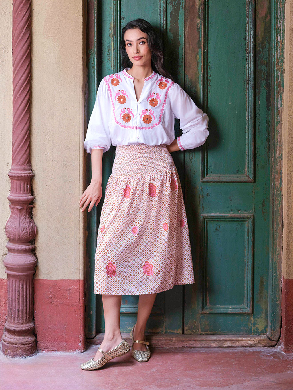 Model showcasing the comfortable movement and artisanal charm of the smocked Lads Love cotton skirt.