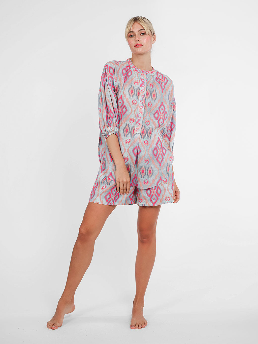 Model wearing the Lilly Pilly linen shorts in ikat sorbet, paired with a matching blouse for an oversized, loose summer look