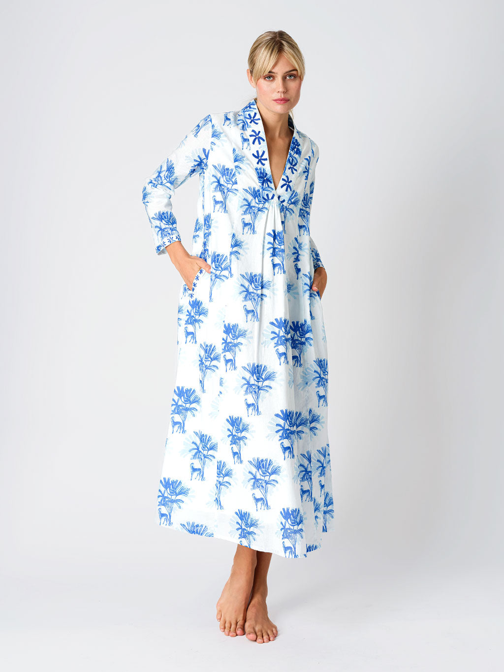 Ankle-length Sandalwood dress by Nimo With Love in white organic cotton with a blue Zebra and palm print