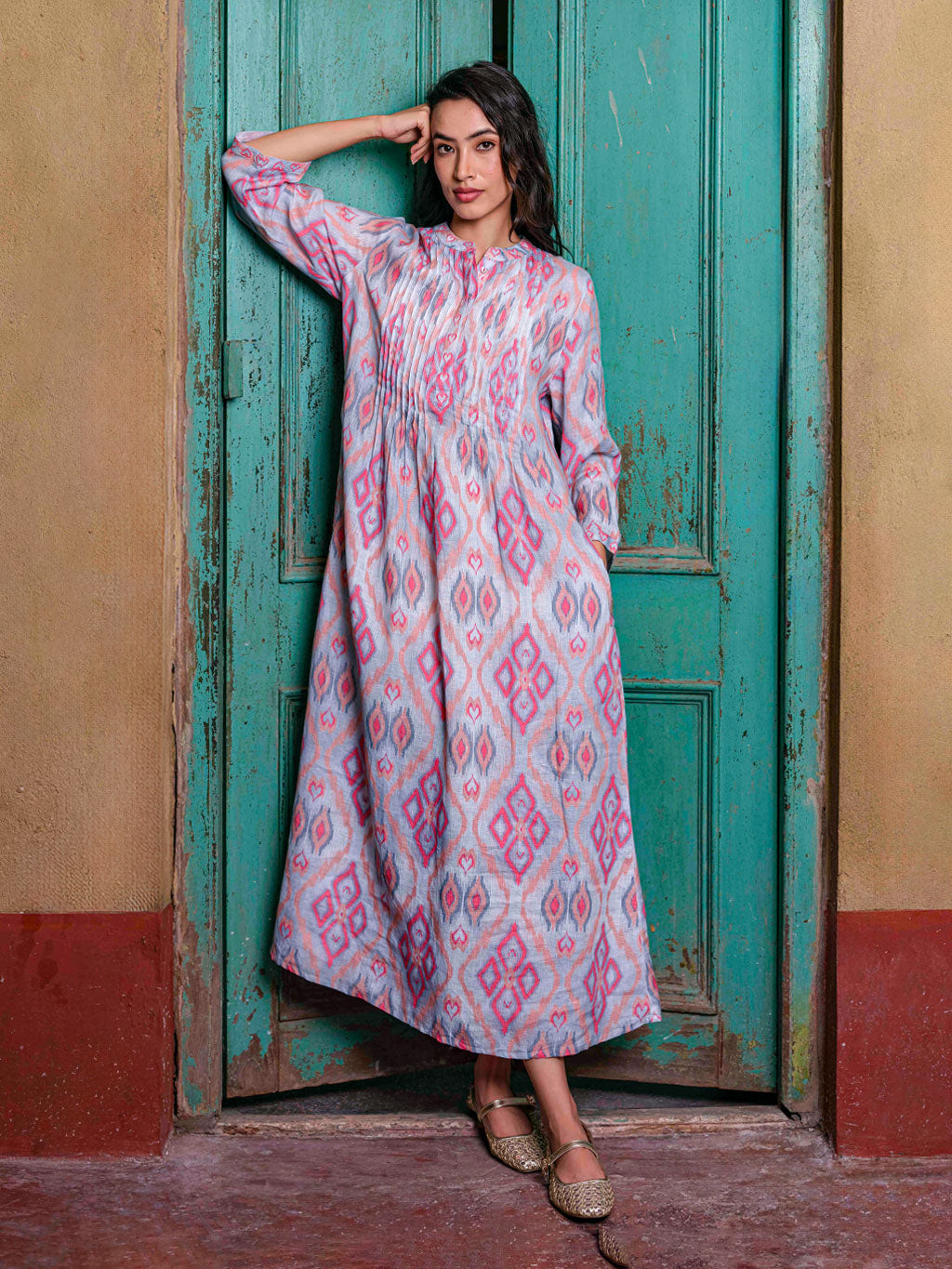 Ankle-length Woodruff dress by Nimo With Love in ikat sorbet linen featuring intricate vertical pleating on the bodice.