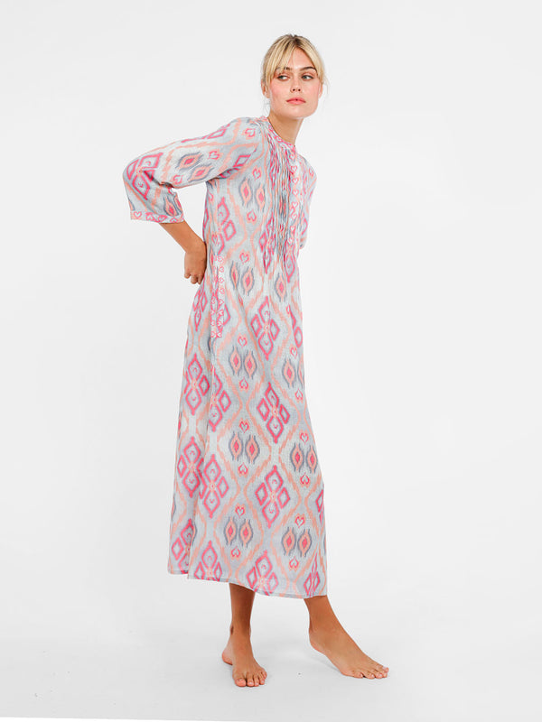 Side view of the Woodruff dress showcasing the rhythmic pleats and the fluid drape of the premium linen fabric.