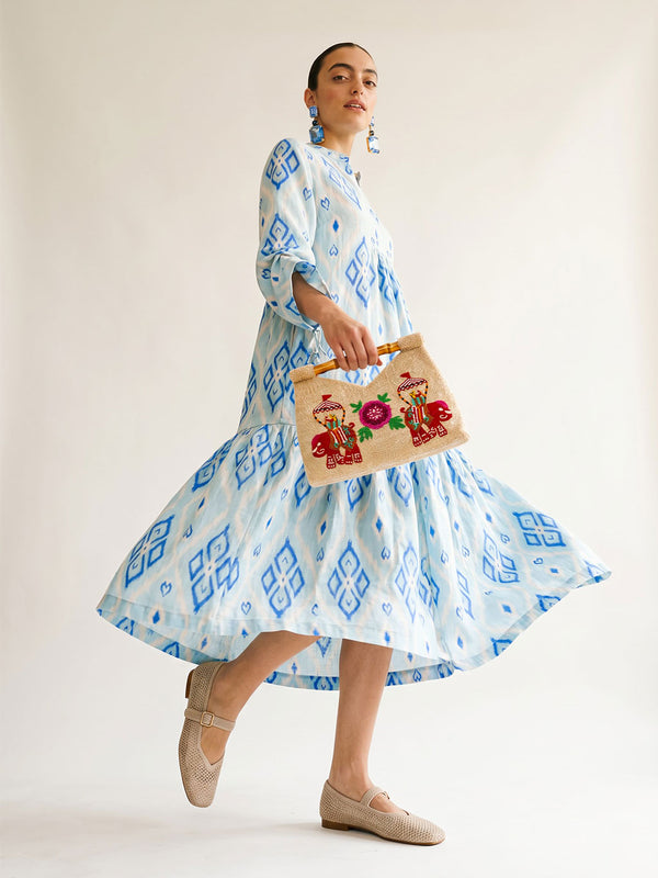 Front tiered gathered flounce hemline on the ankle-length light blue linen Catmint dress.