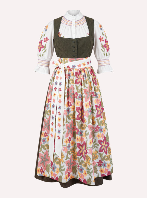 A traditional German dirndl dress featuring the white Nimo dirndl blouse with colorful floral embroidery on the sleeves and the Nimo dirndl apron with a vibrant multicolor floral cross stitch pattern.