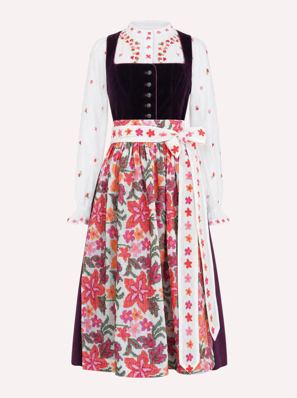 A traditional German dirndl dress featuring a white Nimo dirndl blouse with colorful floral embroidery on the sleeves and the Nimo dirndl apron with a vibrant multicolor floral cross stitch pattern.