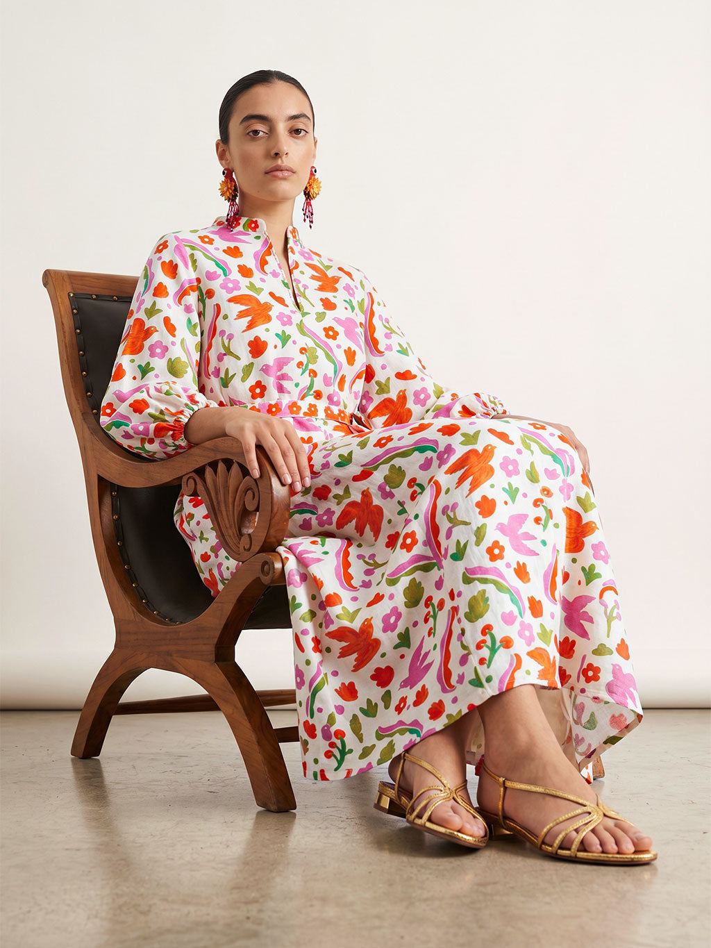 Studio fashion shot of the bohemian Marigold maxi dress in a multi-colored floral and bird print.