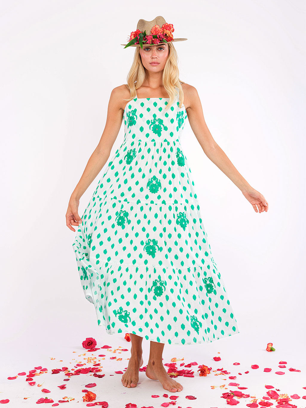 Model wearing the Cornflower dress with a straw hat, embodying effortless Mediterranean summer style.