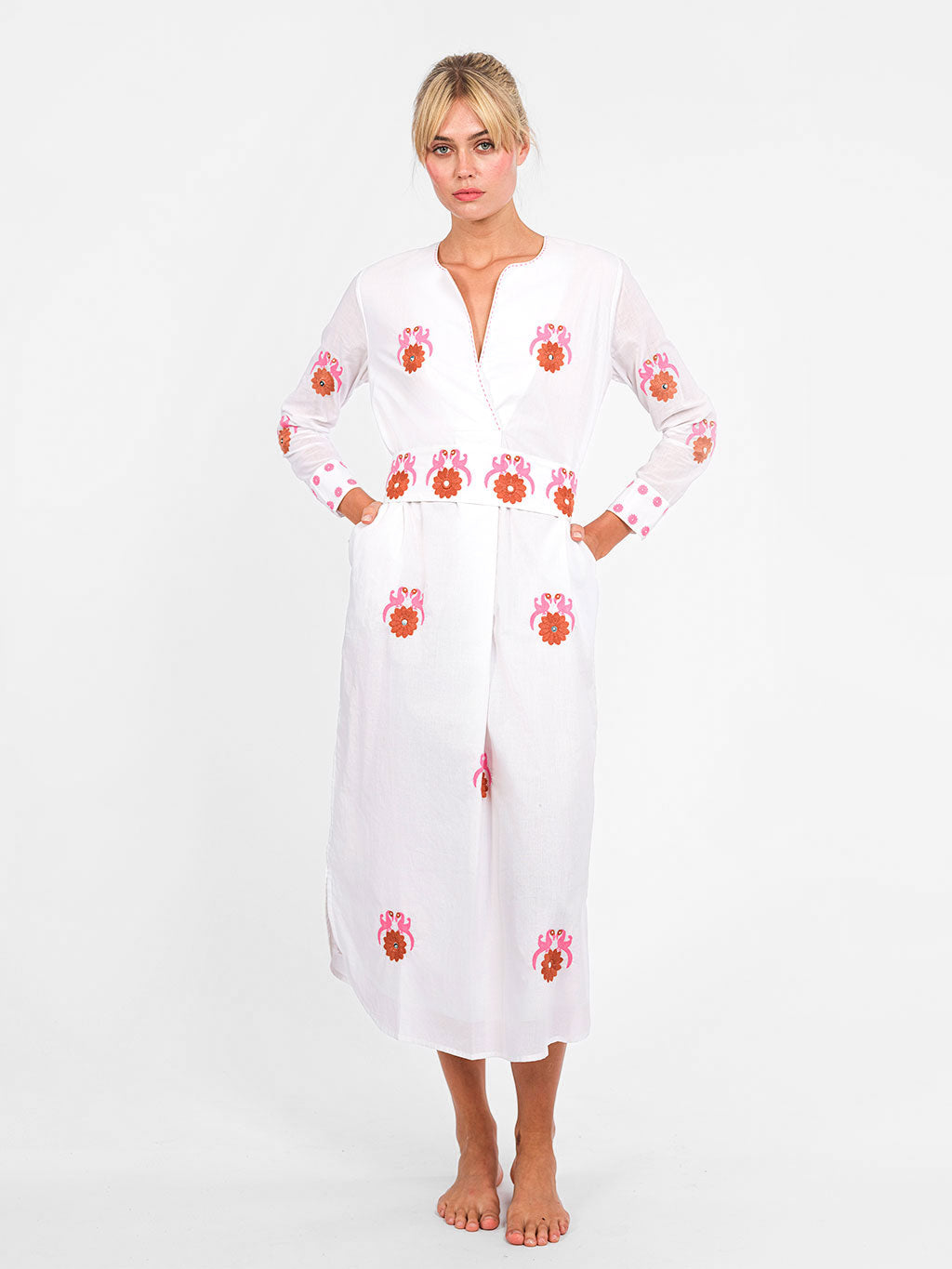White organic cotton Amethyst Kaftan dress by Nimo With Love with pink and orange bird embroidery and a wrap-effect neckline
