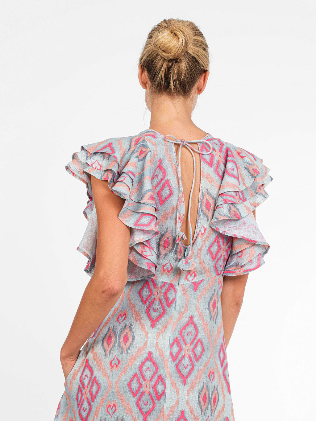 Close-up of the adjustable back-tie detail and the feminine V-neck design of the Belladonna resort dress.