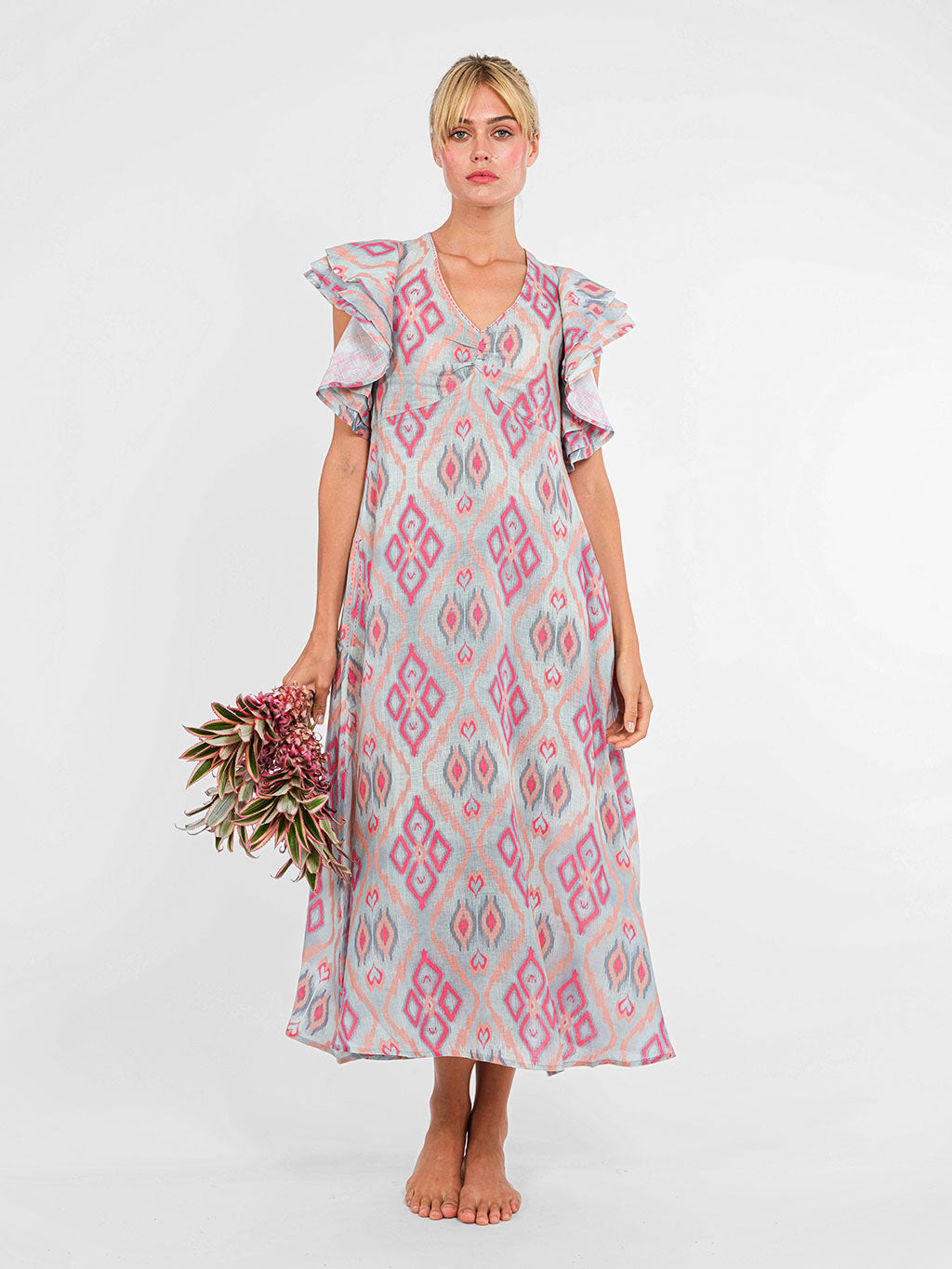 Midi-length Belladonna dress by Nimo With Love in grey and coral ikat linen with statement ruffled cap sleeves and V-neck front and back
