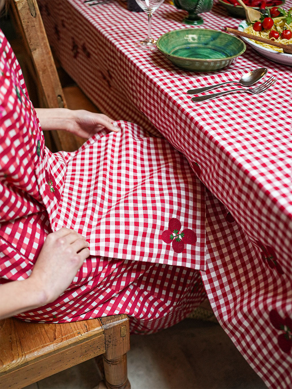 Nimo x Stefania Lettini luxury gingham napkins with hand-guided tomato embroidery in a vibrant red and white check.
